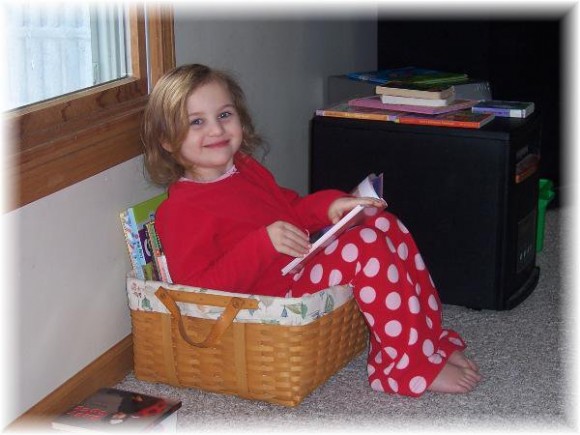 Tori caught in the act of reading pragmatic mom pragmaticmom child reading in reading basket cute girl