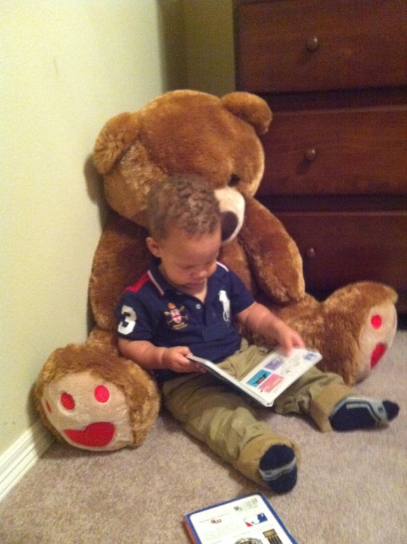 reading with giant teddy bear, caught in the act of reading