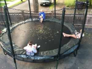kids reading on trampoline