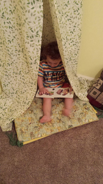 kid reading in tent