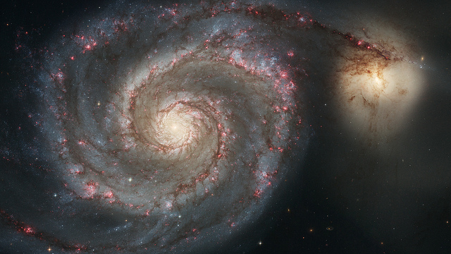 The graceful, winding arms of the majestic spiral galaxy M51 (NGC 5194) appear like a grand spiral staircase sweeping through space. They are actually long lanes of stars and gas laced with dust. 